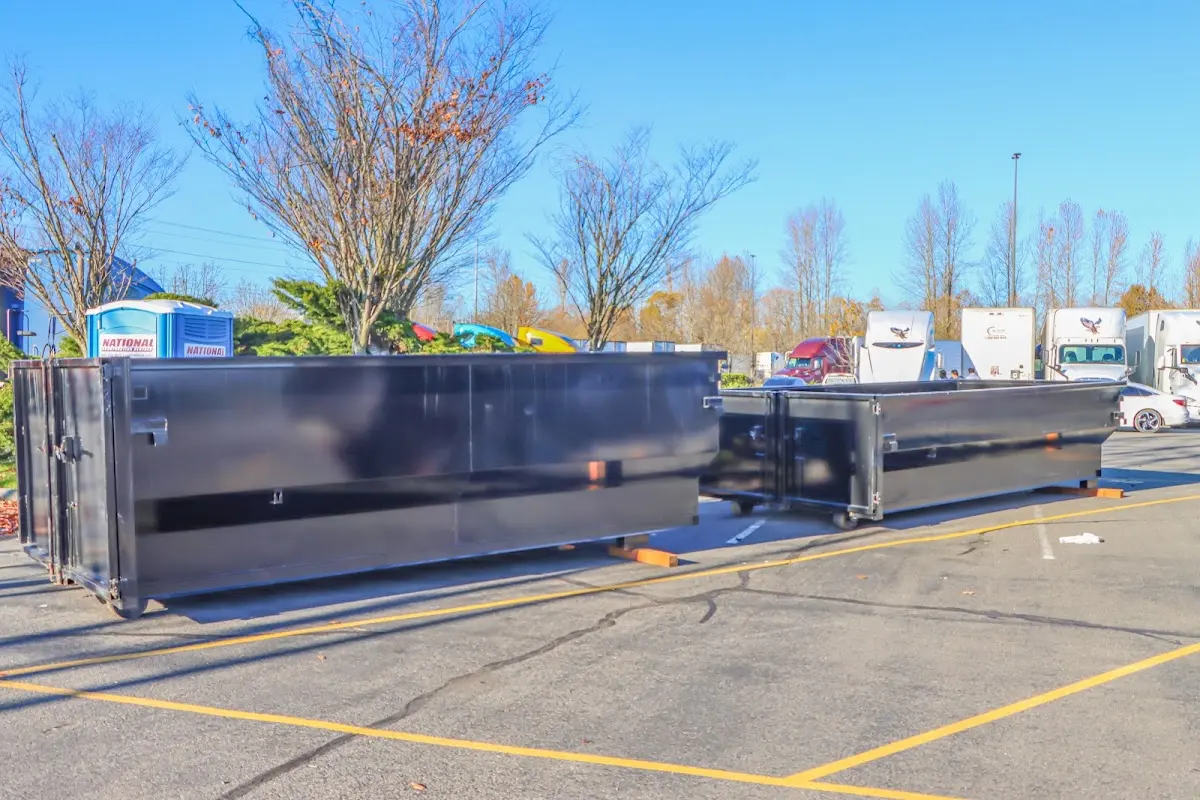 Professional dumpster rental service with roll-off container on residential driveway in Golden Valley